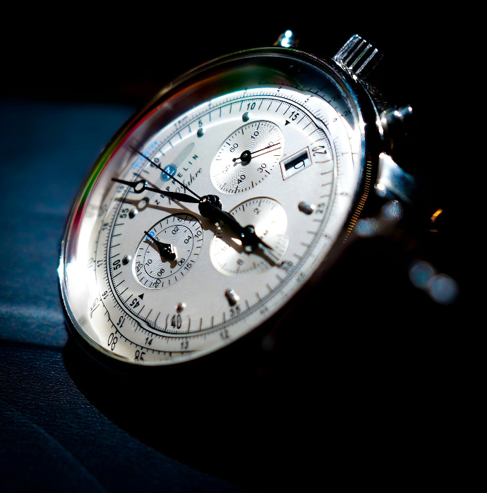 A close up of a watch on a black surface